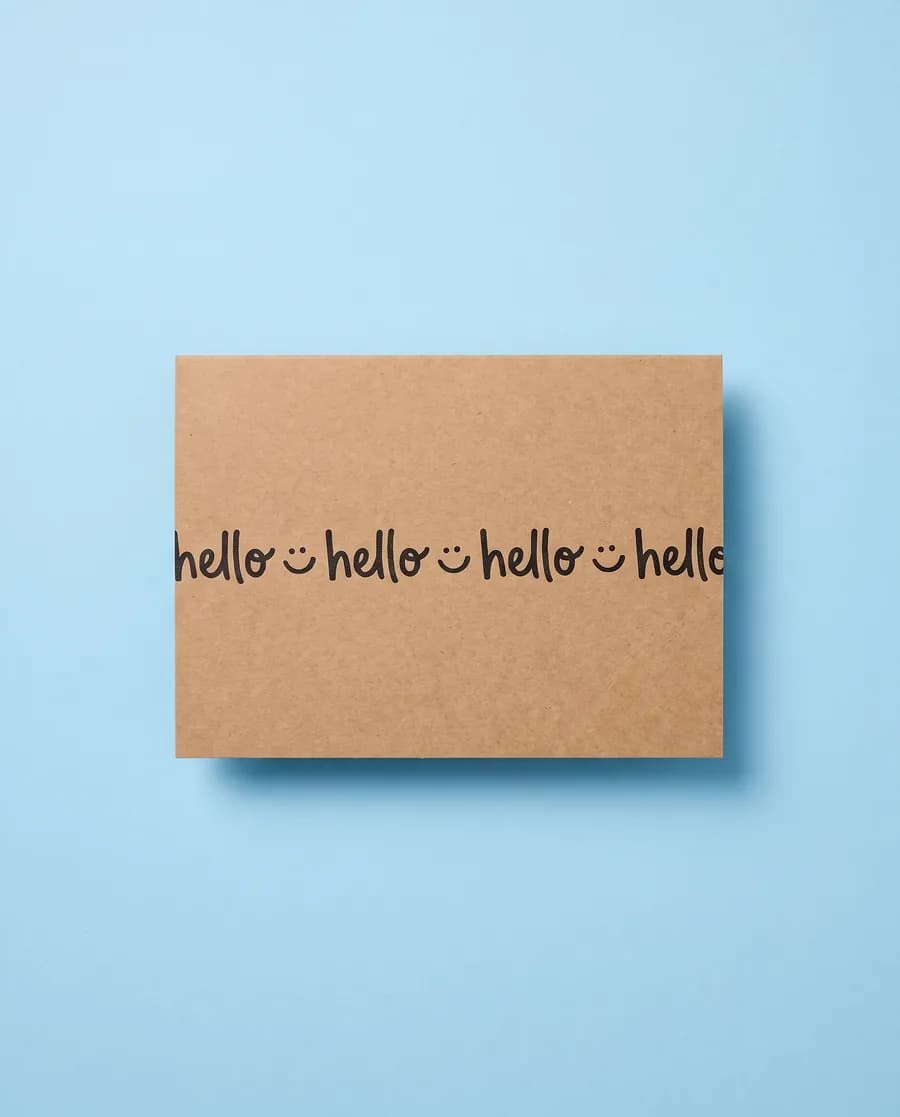 Kraft proof card on light blue: hello with a smiley repeating on a single 14 mm line, printed with a Rolly M