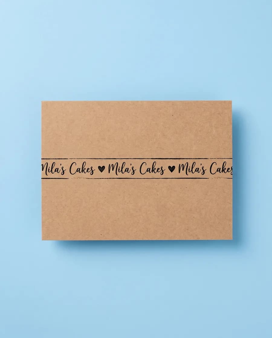 Kraft proof card on light blue: Mila's Cakes in script on a single 14 mm line, printed with a Rolly M