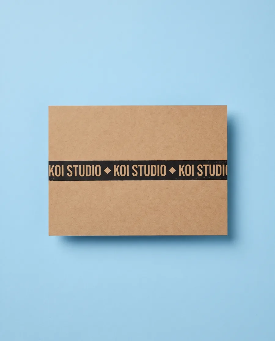 Kraft proof card on light blue: Koi Studio, an inverted single 14 mm line, printed with a Rolly M